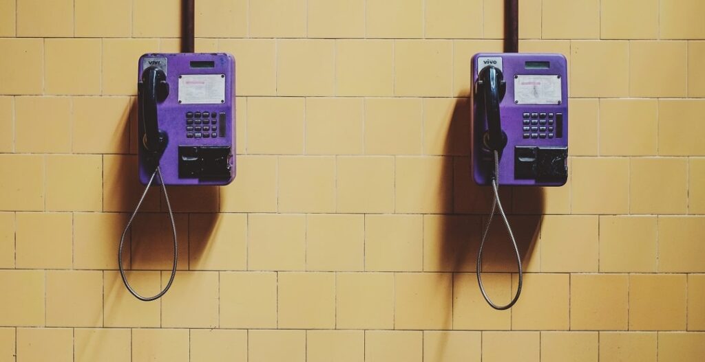 Purple phones attached to a wall