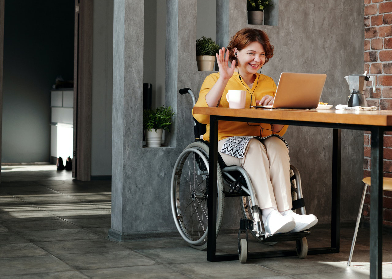 Woman in a wheelchair behind laptop