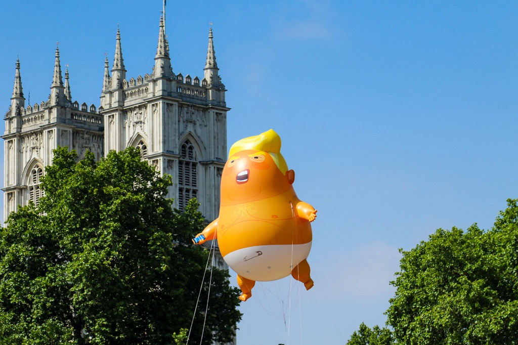 A yellow Trump balloon floats above London
